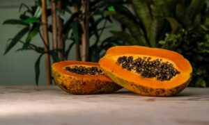 Pods of split papaya fruit displaying the seeds