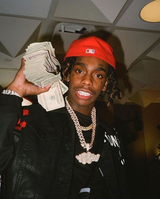 YNW Melly holds a bundle of cash